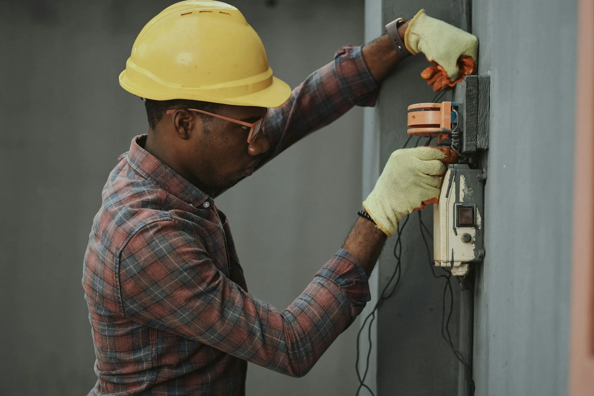 Electrician installing wiring on site
